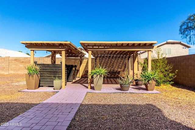 view of yard featuring a patio area, a fenced backyard, and a pergola