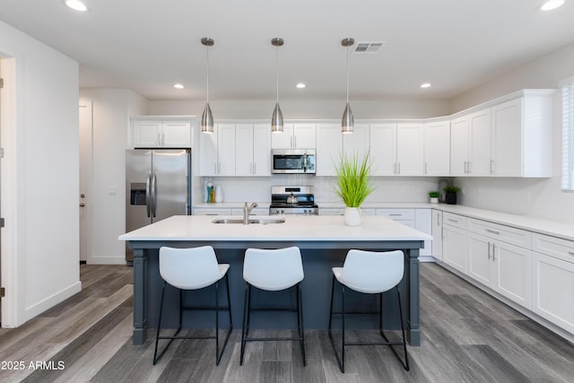 475 S Soho Ln Unit 35, Chandler, AZ 85225 - kitchen with decorative light fixtures, light countertops, appliances with stainless steel finishes, white cabinets, and a sink