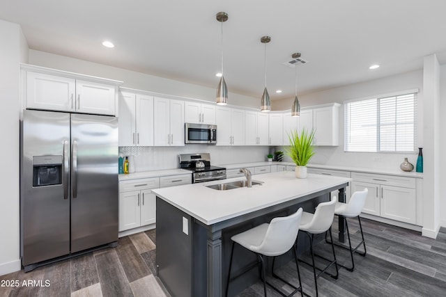 475 S Soho Ln Unit 35, Chandler, AZ 85225 - kitchen with white cabinets, appliances with stainless steel finishes, light countertops, and hanging light fixtures