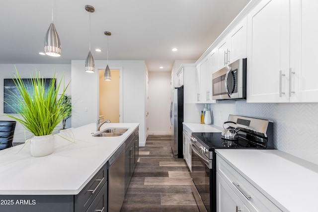 475 S Soho Ln Unit 35, Chandler, AZ 85225 - kitchen featuring a center island with sink, white cabinets, decorative light fixtures, stainless steel appliances, and a sink