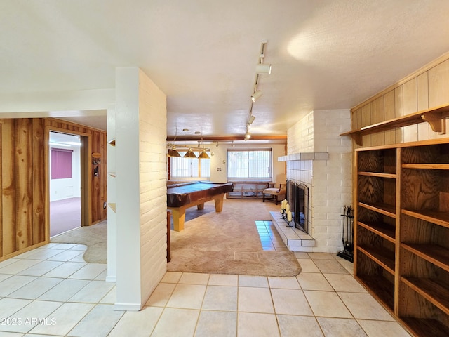 4950 Raffaele Dr, Sierra Vista, AZ 85635 - rec room with billiards, light tile patterned floors, light colored carpet, a brick fireplace, and rail lighting