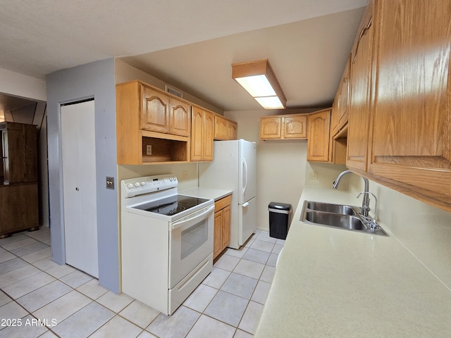 4950 Raffaele Dr, Sierra Vista, AZ 85635 - kitchen featuring white appliances, a sink, light tile patterned flooring, and light countertops