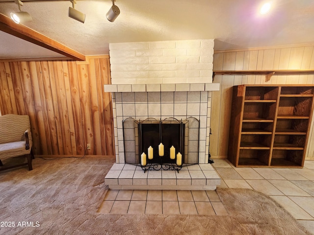 4950 Raffaele Dr, Sierra Vista, AZ 85635 - unfurnished living room featuring wood walls, a large fireplace, baseboards, and tile patterned flooring