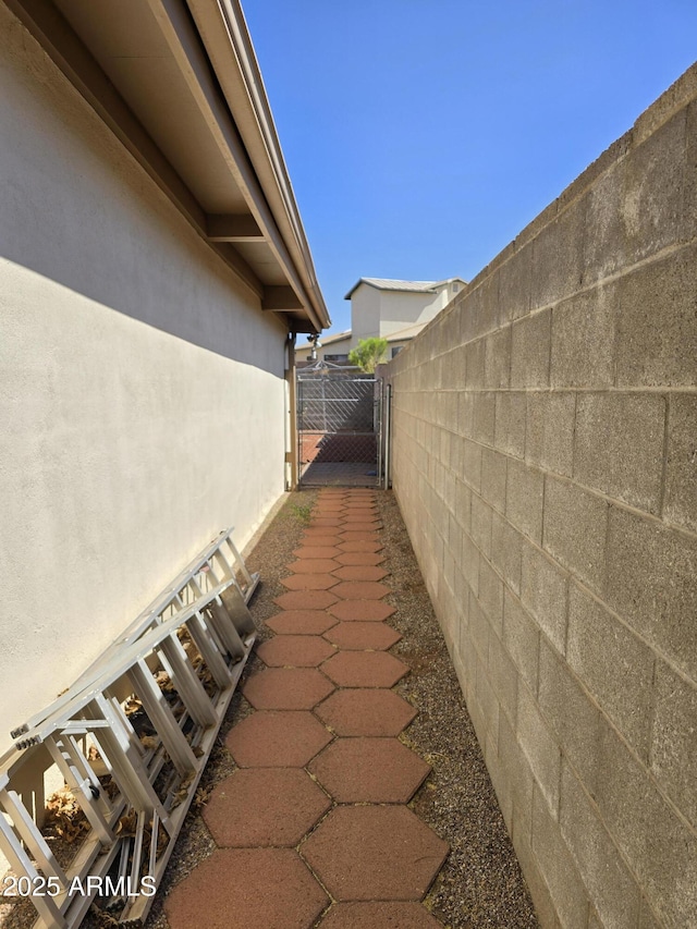 4950 Raffaele Dr, Sierra Vista, AZ 85635 - view of side of home with a gate and stucco siding