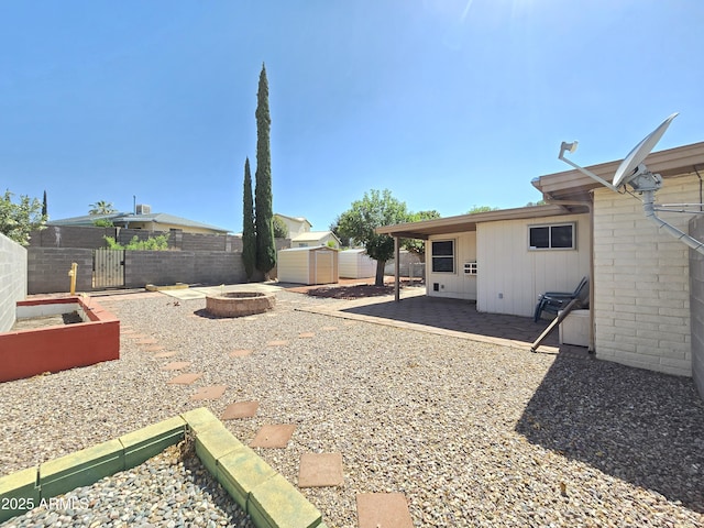 4950 Raffaele Dr, Sierra Vista, AZ 85635 - fenced backyard featuring a fire pit and a patio area
