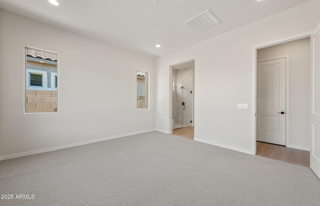 unfurnished bedroom with light carpet, visible vents, baseboards, connected bathroom, and recessed lighting