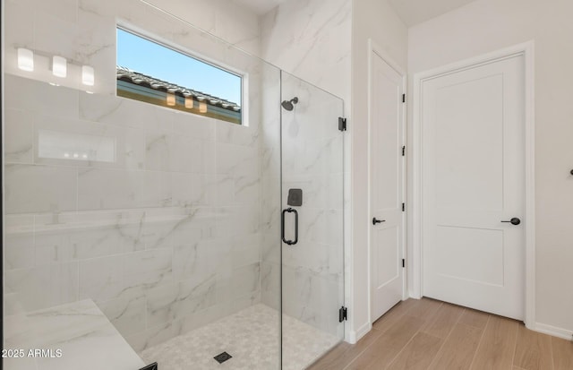 bathroom featuring a stall shower and wood finished floors