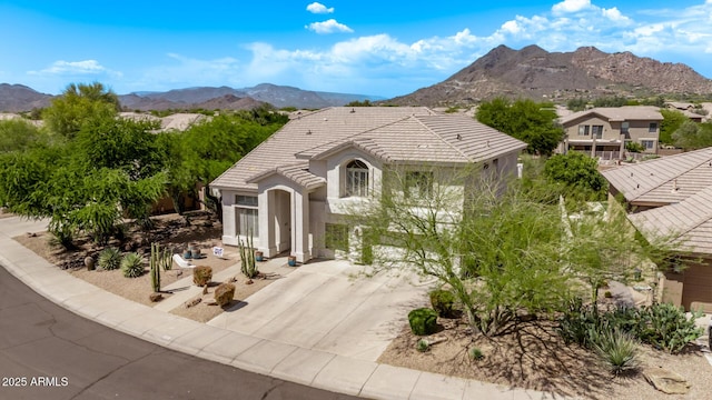 6026 E Sonoran Trl, Scottsdale, AZ 85266 - view of front of property featuring a mountain view, driveway, a tiled roof, and stucco siding