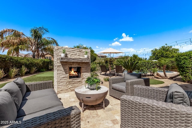 6026 E Sonoran Trl, Scottsdale, AZ 85266 - view of patio with an outdoor living space with a fireplace