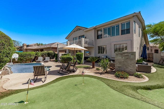 6026 E Sonoran Trl, Scottsdale, AZ 85266 - back of house featuring an area to practice putting, a balcony, a patio area, and stucco siding