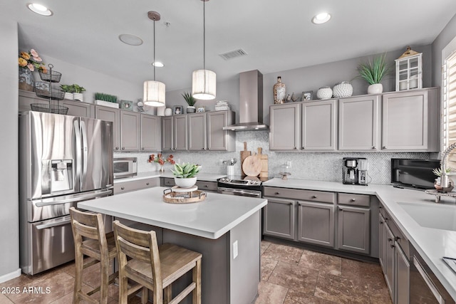 6026 E Sonoran Trl, Scottsdale, AZ 85266 - kitchen featuring stainless steel appliances, wall chimney range hood, gray cabinets, decorative backsplash, and recessed lighting