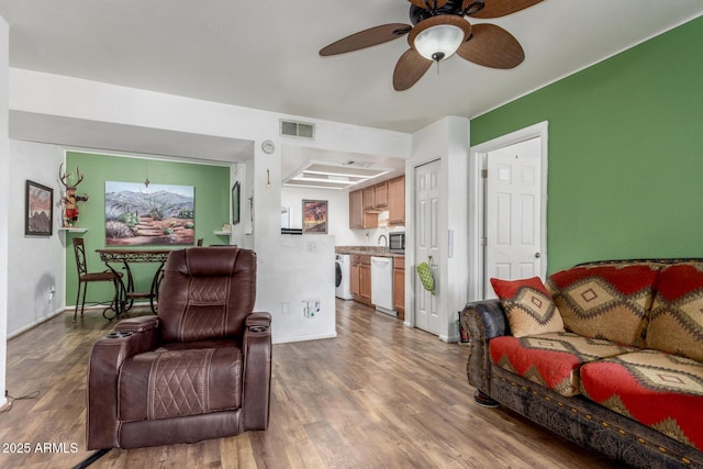 16602 N 25th St Unit 204, Phoenix, AZ 85032 - living room with washer / clothes dryer, a ceiling fan, wood finished floors, and baseboards