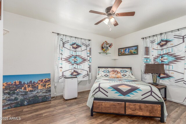 16602 N 25th St Unit 204, Phoenix, AZ 85032 - bedroom featuring wood finished floors, baseboards, and ceiling fan