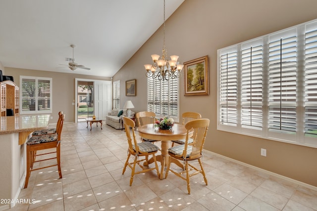 dining area with light tile patterned floors, ceiling fan with notable chandelier, baseboards, and visible vents
