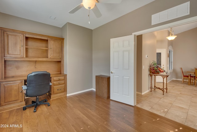 office space featuring a ceiling fan, baseboards, light wood-style floors, and visible vents