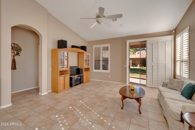 tiled living room featuring ceiling fan and high vaulted ceiling