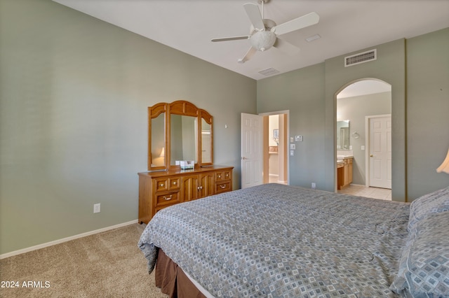 carpeted bedroom with ceiling fan and ensuite bathroom