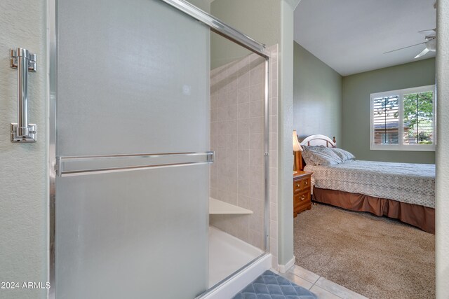 bathroom with tile patterned flooring, ceiling fan, and an enclosed shower