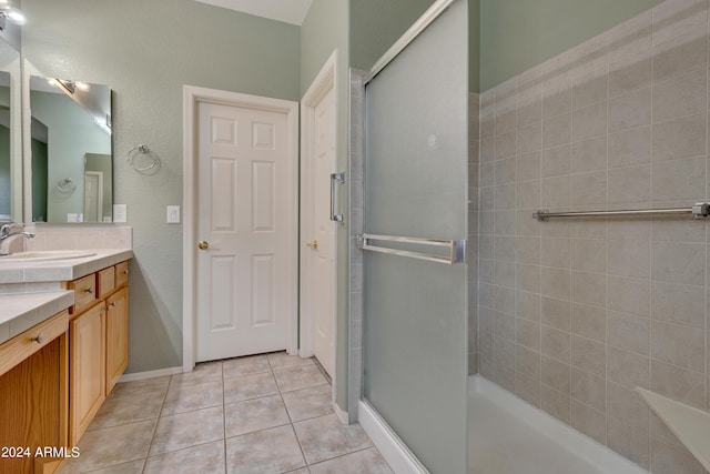 bathroom featuring a shower stall, tile patterned floors, baseboards, and vanity