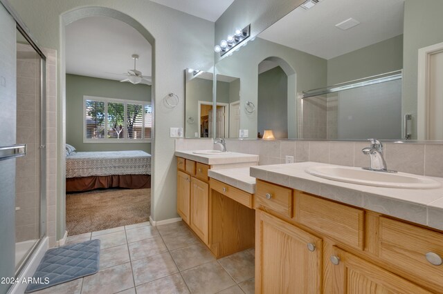 bathroom featuring ceiling fan, vanity, tile patterned flooring, and an enclosed shower