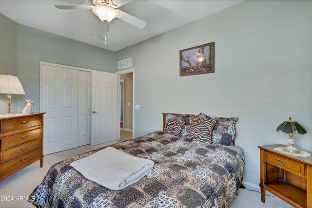 carpeted bedroom with ceiling fan and a closet