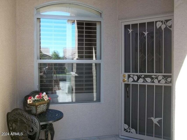 property entrance with stucco siding