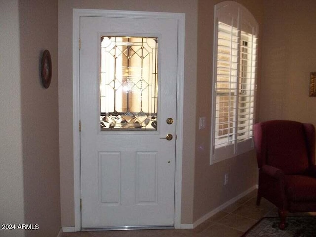 foyer with tile patterned floors and baseboards