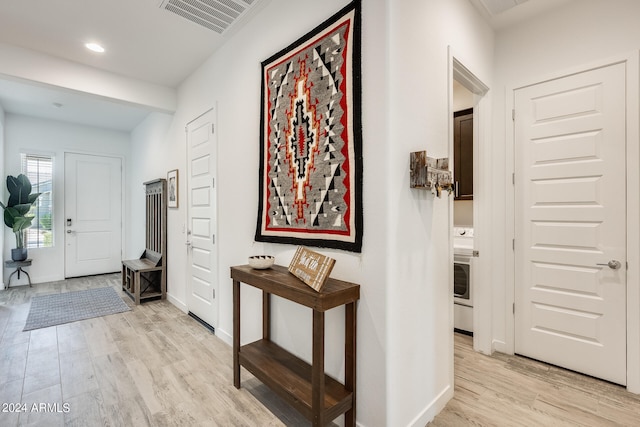 hallway with light hardwood / wood-style floors