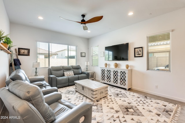 living room featuring ceiling fan and light hardwood / wood-style flooring