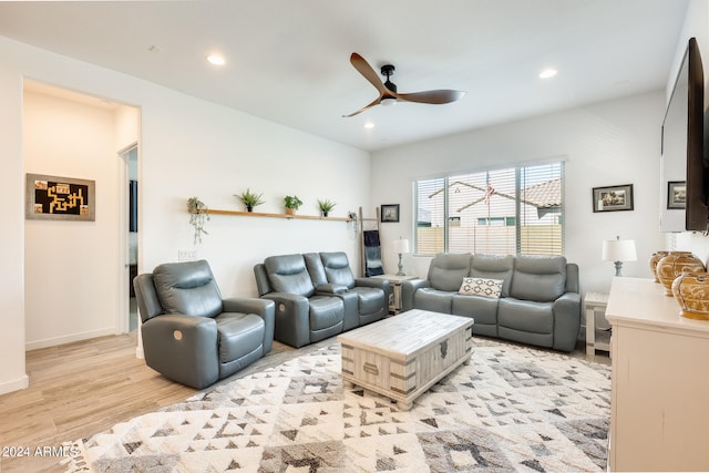 living room featuring ceiling fan and light wood-type flooring