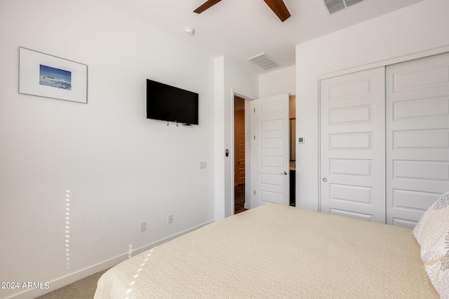 bedroom with a closet, ceiling fan, and carpet flooring