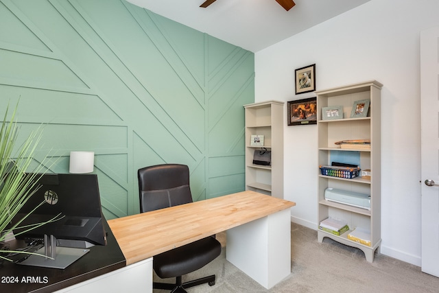 carpeted home office featuring ceiling fan