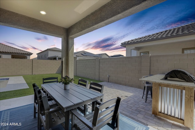 view of patio terrace at dusk