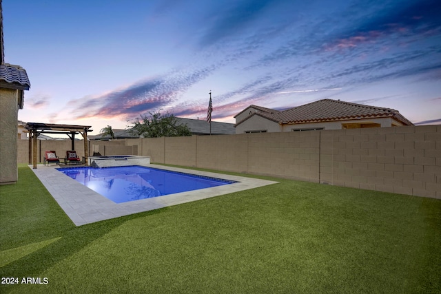 pool at dusk with an in ground hot tub, a yard, a pergola, and a patio area