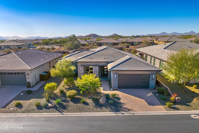 view of front of property with a garage and a mountain view