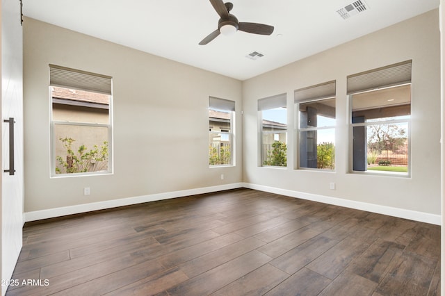 spare room featuring ceiling fan and dark hardwood / wood-style flooring