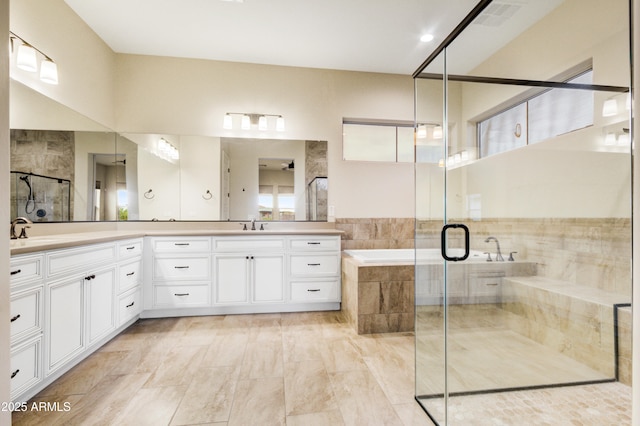 bathroom featuring vanity and separate shower and tub