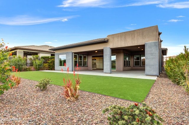 rear view of property with a patio area and a lawn