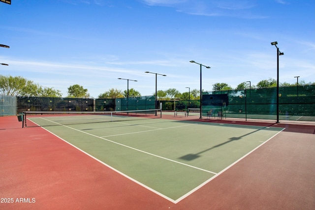 view of tennis court featuring basketball hoop