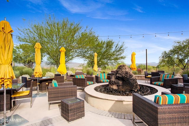 view of patio / terrace featuring an outdoor living space with a fire pit