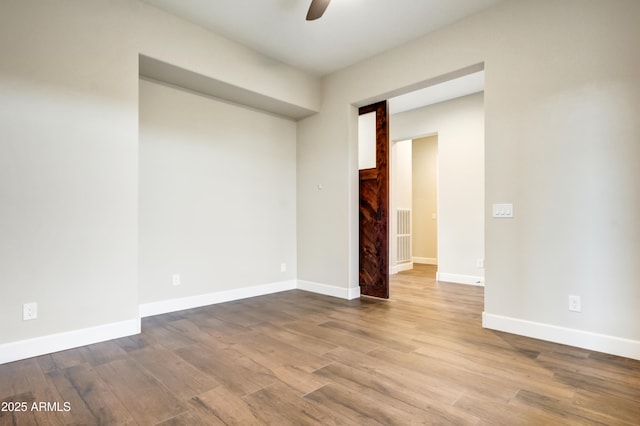 unfurnished room featuring light hardwood / wood-style flooring and ceiling fan