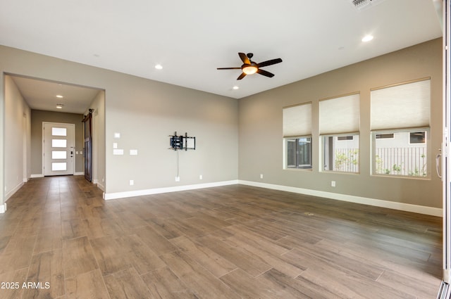 unfurnished living room featuring hardwood / wood-style floors and ceiling fan