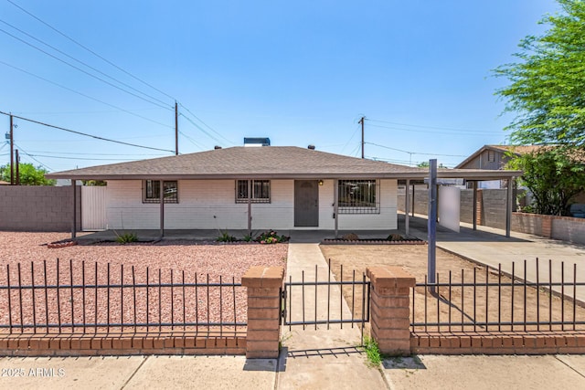 2721 W Luke Ave, Phoenix, AZ 85017 - view of front facade with a shingled roof, driveway, a fenced front yard, a carport, and brick siding
