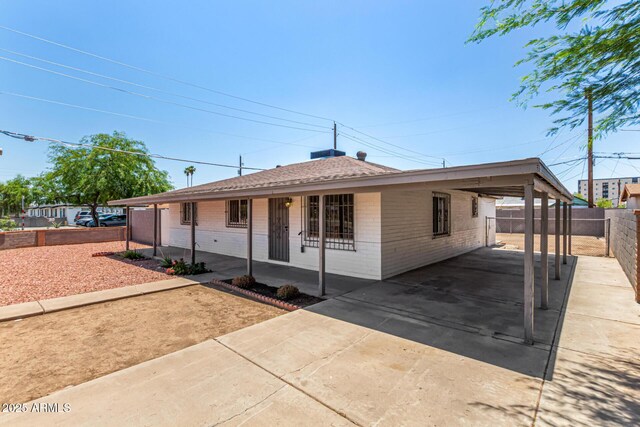 2721 W Luke Ave, Phoenix, AZ 85017 - view of front facade featuring concrete driveway, a carport, brick siding, and covered porch