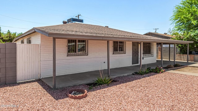 2721 W Luke Ave, Phoenix, AZ 85017 - view of front of property with a shingled roof, a patio area, central AC unit, and brick siding