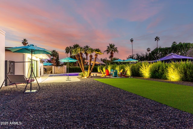 675 Val Verde Cir W, Litchfield Park, AZ 85340 - yard at dusk featuring fence and a patio
