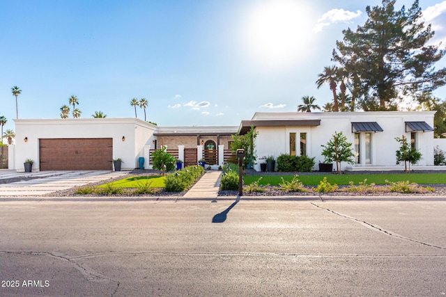 675 Val Verde Cir W, Litchfield Park, AZ 85340 - view of front of house with stucco siding, an attached garage, and concrete driveway