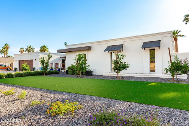 675 Val Verde Cir W, Litchfield Park, AZ 85340 - modern home with stucco siding, an attached garage, and a front lawn