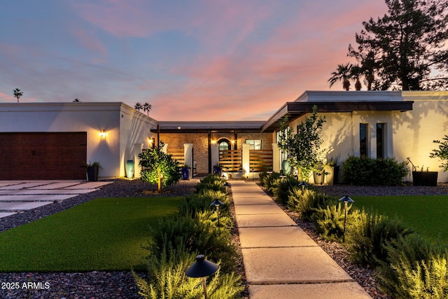 675 Val Verde Cir W, Litchfield Park, AZ 85340 - view of front of house with stucco siding, driveway, and a garage