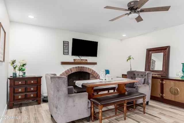 675 Val Verde Cir W, Litchfield Park, AZ 85340 - living area with light wood-style flooring, ceiling fan, a brick fireplace, recessed lighting, and baseboards